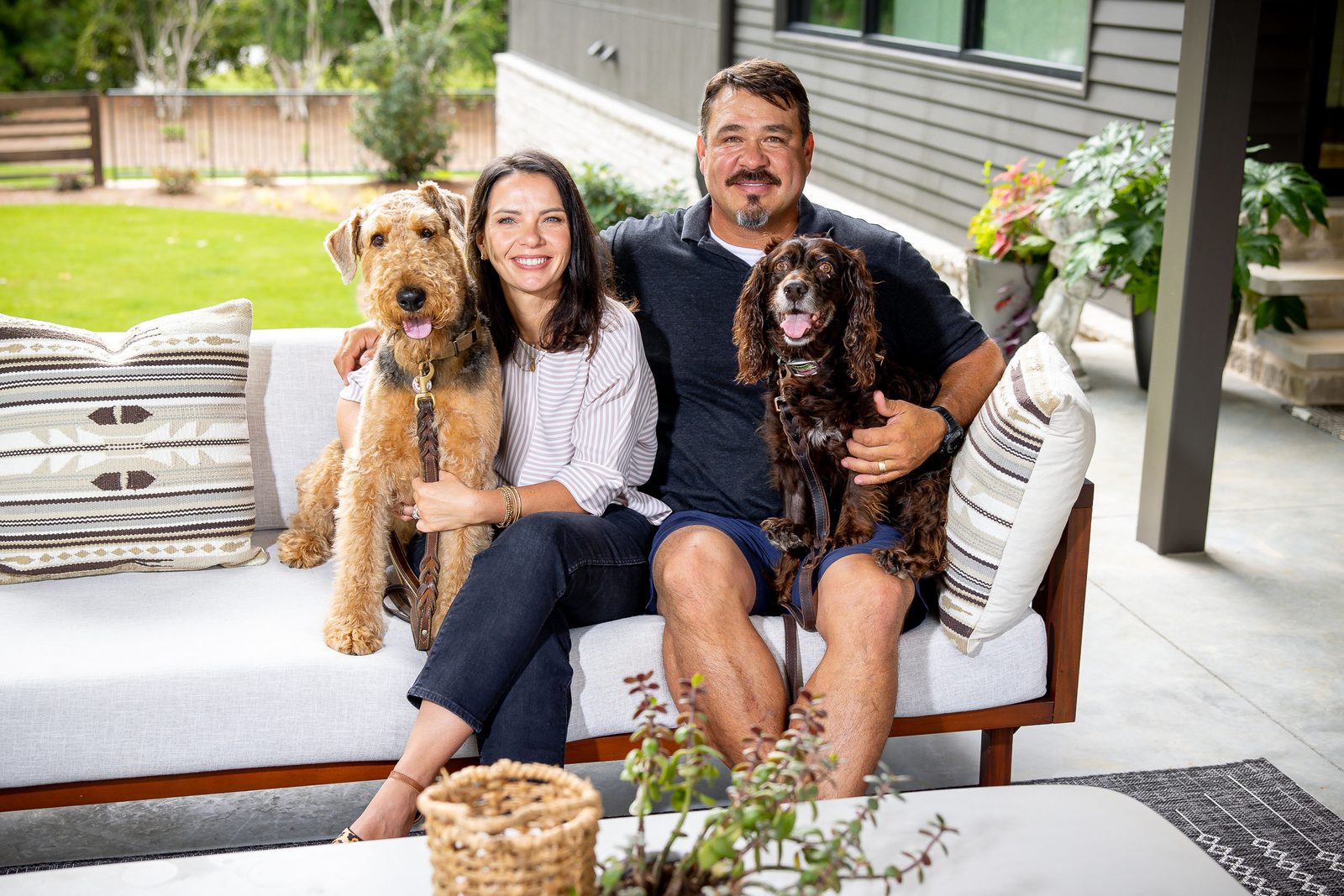 Family portrait on the patio daybed — The Ortiz Home, custom home built by Ironwood Construction Group in Sugar Hill, Georgia