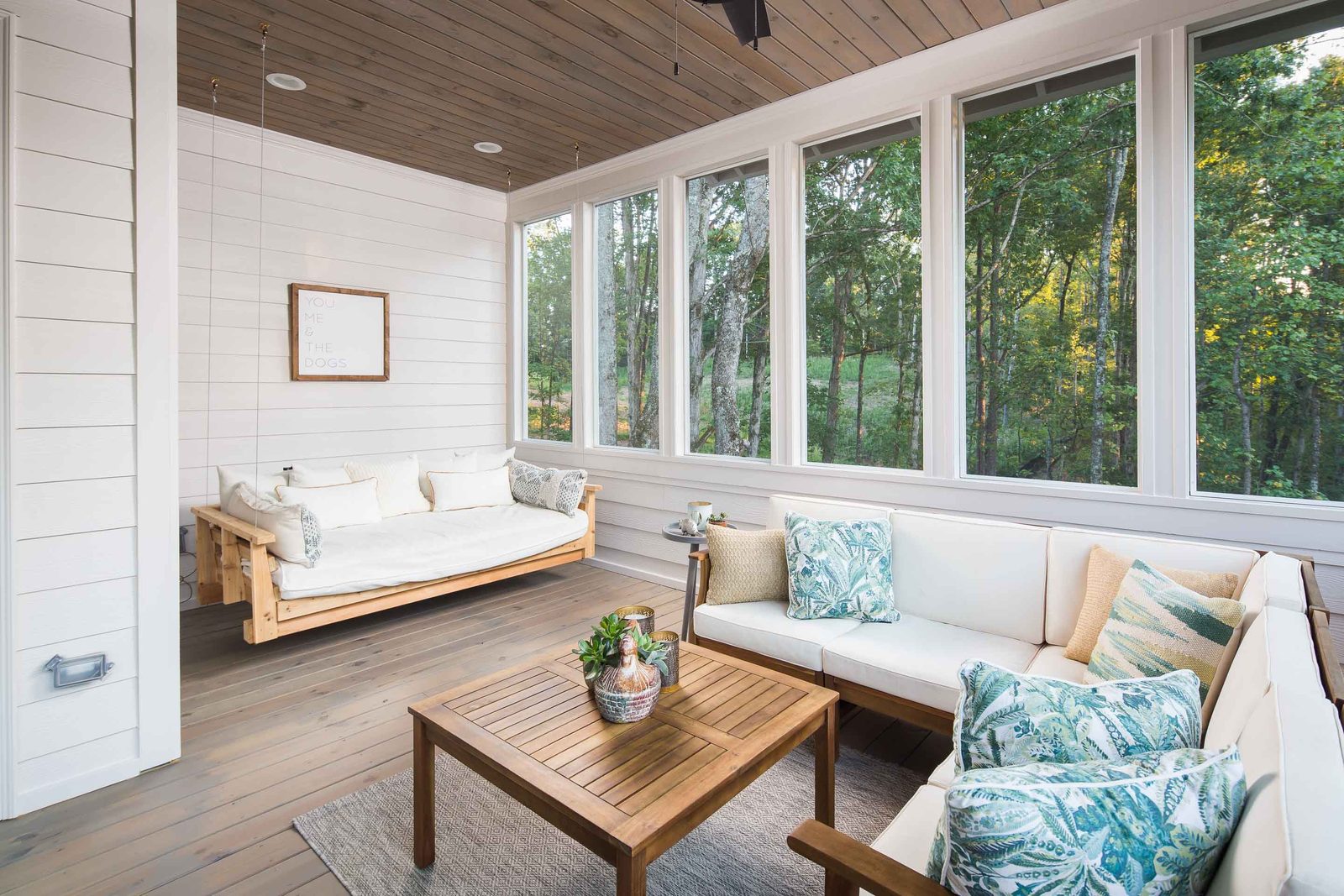 Screened porch with hanging daybed and built-in bench — Austin Garner Rd, custom home built by Ironwood Construction Group