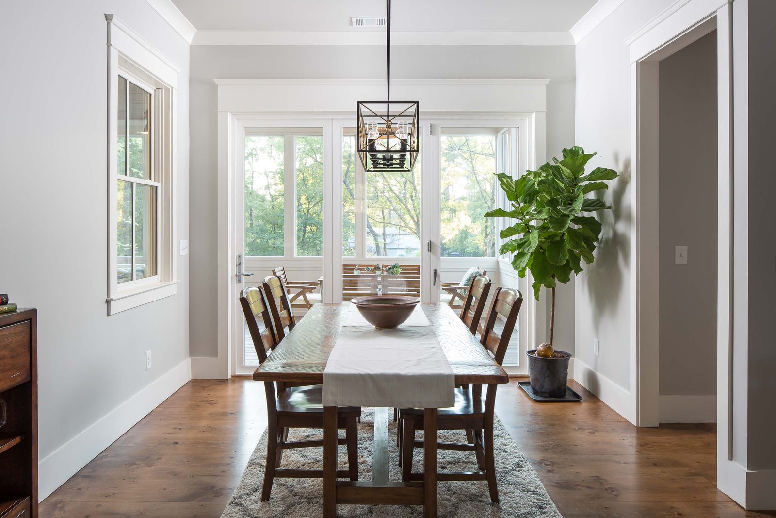 Dining room with lantern chandelier and hardwood floor — Austin Garner Rd, custom home built by Ironwood Construction Group