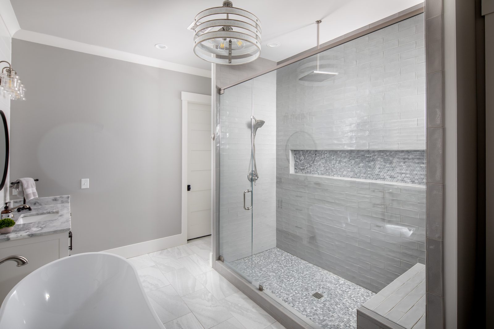 Primary bath walk-in shower with tiled bench — Spring 2020 Custom Home, custom home built by Ironwood Construction Group